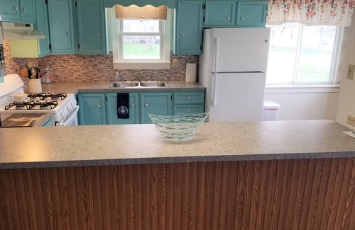Essexville House | Open concept 2 bedroom ranch with attached garage and deck