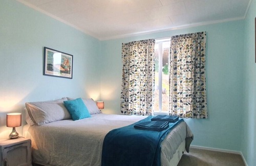 Opito Bay House | Opito Bay Charmer - Sun drenched family bach is a real charmer.