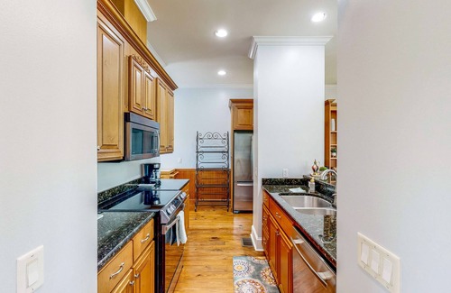 St. Marys House | Palm-lined home with dock access, firepit & inviting balconies