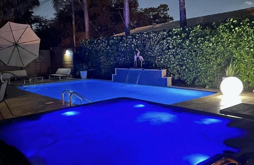 Poinsettia Heights Villa | Palms Retreat! Giant Heated Pool-HotTub-FirePit-5Min2Beach-Pets-EV Chgr