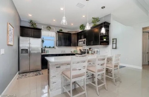 Trafalgar House | Paradise of Cape Coral on Canal, with Heated Pool, Tiki Hut Grill & Elec Bikes