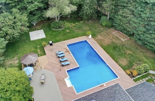Shirley House | Peaceful Beach Retreat - Heated Pool, Big Backyard, Mini-Bar & Game Room