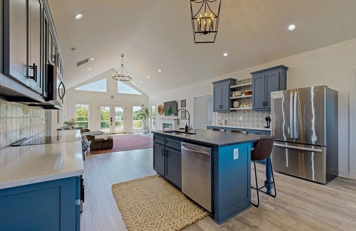 Orange House | Peaceful retreat with hot tub, fire pit, games, kayaks, and water view