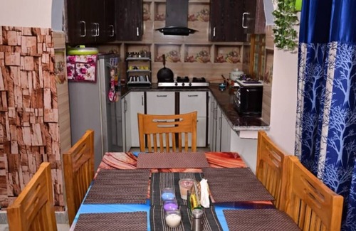 Rajgarhi House | Peaceful stay : 2-bedroom, bright living area, kitchen, terrace, and garden