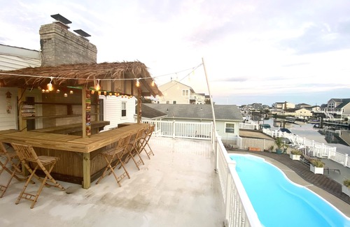 Osborn Island House | POOL, TIKI BAR, WATERFRONT home, 8 LBI Beach passes in Mystic Island NJ