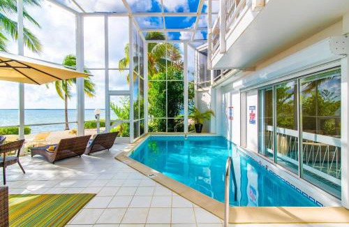 Rum Point Apartment | Pools of the Kai 3 - Waterfront Condo with Private Pool Atrium, Walk to Restaurants