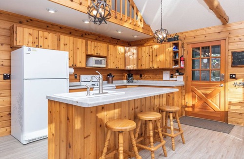 Eagle River House | Porch in the Pines | Lakefront home w/AC! Sandy Beach, Dock, Dogs OK