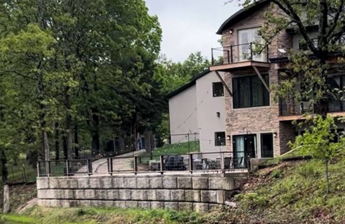 Joplin House | Private getaway in modern mountain design. Overlooking water on deck in nature.