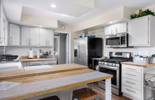 Huron House | Private ranch home with hot tub, playset, fire pit, and a nice lighted deck