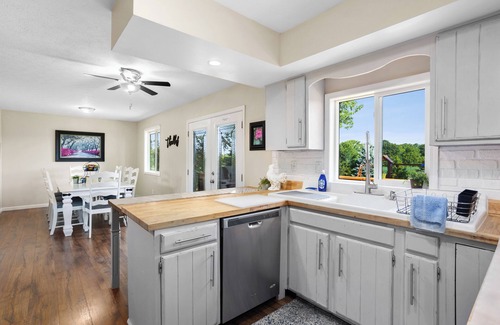 Huron House | Private ranch home with hot tub, playset, fire pit, and a nice lighted deck