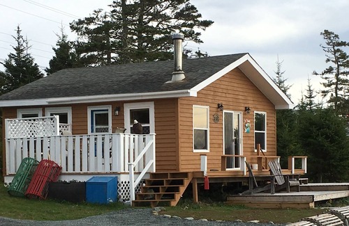 Liscomb Cottage | Private self contained cottage with terraced decking right to the water.