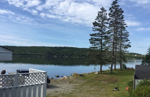 Liscomb Cottage | Private self contained cottage with terraced decking right to the water.