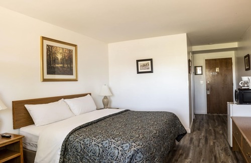Delta Hotel | Quaint Single King Hotel Room overlooking the Gunnison River and your Private Patio! Perfect for fishing and exploring the outdoors.
