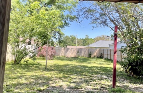 North Northwest Pensacola House | Red Door Bungalow-15 minutes to BEACH + Pet-Friendly!