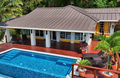 Gibson Bight House | Relax at this hillside retreat that overlooks the lush forest and the Caribbean.