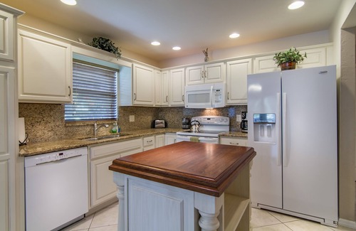 Naples Park House | Relax by the sand at nearby Vanderbilt Beach or hang by heated pool