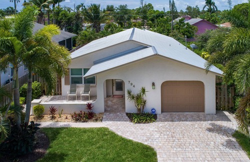Naples Park House | Relax by the sand at nearby Vanderbilt Beach or hang by heated pool