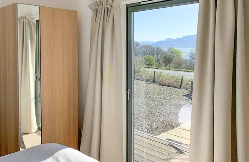 Breakish Cottage | Relax by the wood burner and look out across the sound of Sleat and beyond planning the next day’s a