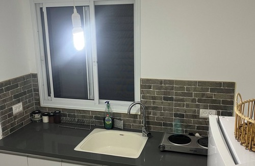 Qiryat Shemona Apartment | Renovated one room unit with a bomb shelter and a garden.