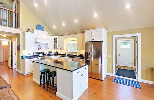 Lamoine Beach Cottage | Renovated waterfront cottage with expansive deck, multiple fireplaces, & grill