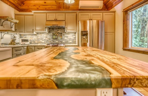 Welches Cabin | Ripplewood, a serene riverfront cabin, decks, hot tub, BBQ, dog-friendly