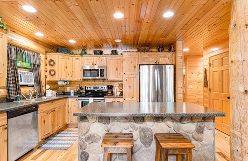 Lyndon Station Cabin | Riverfront cabin with a dock, kayaks and a canoe - firepit and water views