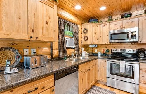 Lyndon Station Cabin | Riverfront cabin with a dock, kayaks and a canoe - firepit and water views