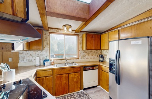 Crescent City House | Riverfront getaway with firepit, deck, fireplace, full kitchen, W/D, & WiFi
