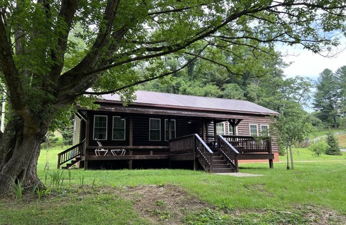 Newland Cabin | Riverfront Luxury Log Cabin with outside fire pit and deck overlooking the water