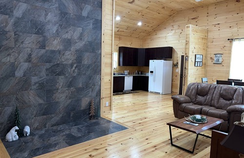Newland Cabin | Riverfront Luxury Log Cabin with outside fire pit and deck overlooking the water