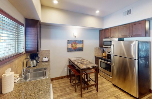 Estes Park Condo | Riverside condo, fish from your patio! Onsite pool & hot tub just steps away.