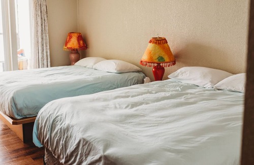 Sointula House | Room 206- Oceanfront room with balcony and two queen beds.