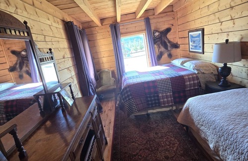 Buckinghorse River Cabin | Room 3 at the Main Lodge with a queen bed and single bed.