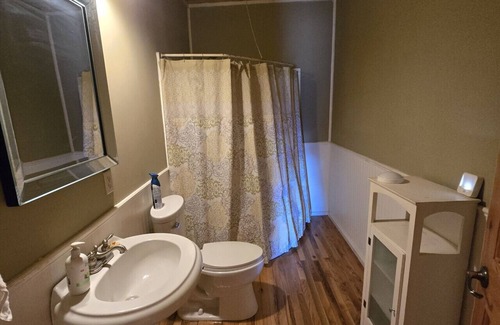Buckinghorse River Cabin | Room 6 at the Main Lodge with a queen bed and single bed.