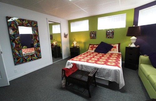 Notre-Dame-des-Monts House | Room in Guest room - Gandhi Very large room decorated in Indian style, office space and sofa