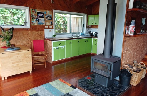 Bethells Beach House | Ruru Cottage nestled at beautiful Bethells Beach