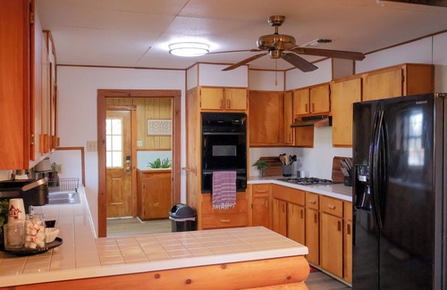 College Station House | Rustic Log Cabin Near Texas A&M – Spacious Retreat with Pond & Firepit!