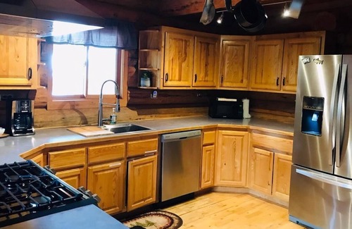 Greenough House | Rustic, spacious, log home nestled into the hillside of 2 acres near river access.