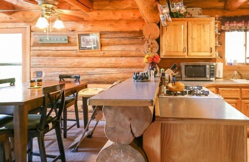 Greenough House | Rustic, spacious, log home nestled into the hillside of 2 acres near river access.