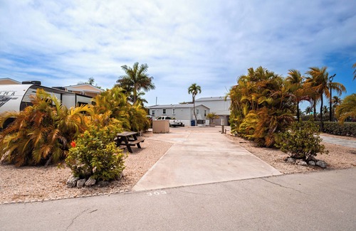 Cudjoe Key RV Rental | RV Lot 303 Venture Out, Pull-through Lot near the Ocean and Pool - Bring your golf cart!