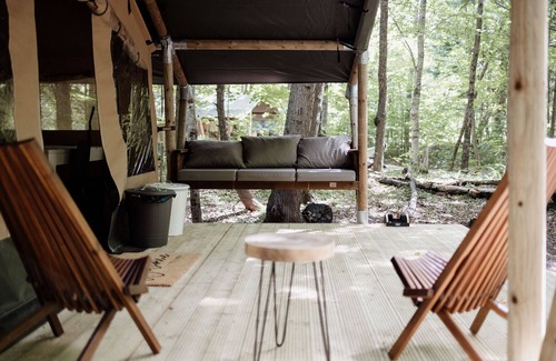 Woodstock RV Rental | Safari Tent Site 11 | 1 King Bed | Woods View