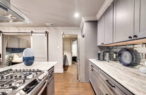 Peak's Suburban Addition Condo | Savor your stay in this elegant Dallas retreat, blending modern comforts with historic charm. Enjoy high-speed Wi-Fi, a smart TV, luxurious king bed, marble finishes, and an award-winning courtyard oasis.