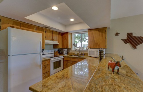 New Braunfels House | Scenic riverfront home on quiet stretch of Guadalupe - waterfall by huge front porch