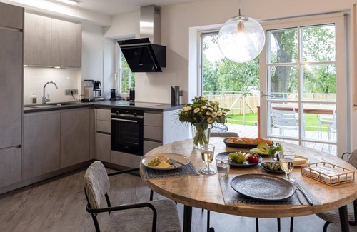 Schrozberg Apartment | Schmalfelden No. 95 with spa oasis in the living room: compact sauna, loungers and fireplace. Fenced garden with great veranda!