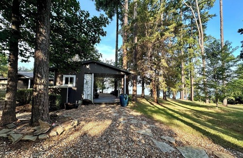 Lafayette County House | Secluded getaway with lakefront views. Spacious covered deck and dock access.