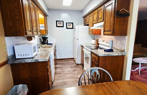 Holiday Island Condo | Six-Person Hot Tub, Lakeside, King Beds, Fireplace!