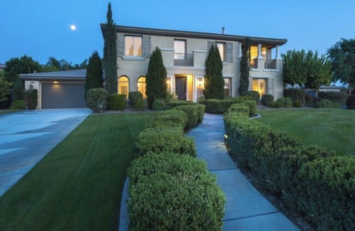 Orchards House | Sleek 4121 sq ft estate with a heated waterfall pool with a slide