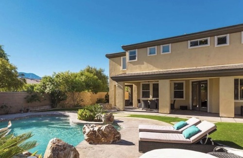 Orchards House | Sleek 4121 sq ft estate with a heated waterfall pool with a slide