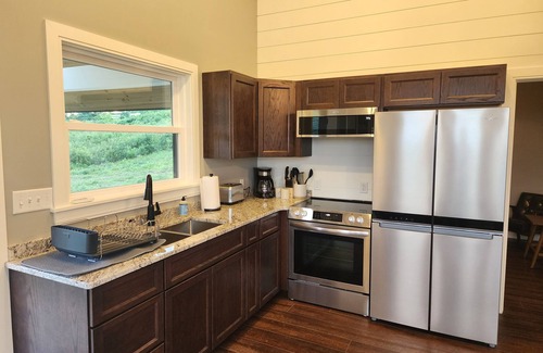 Brooks House | Small cottage house, centered on 100 acres surround by hills, lake, and cattle.