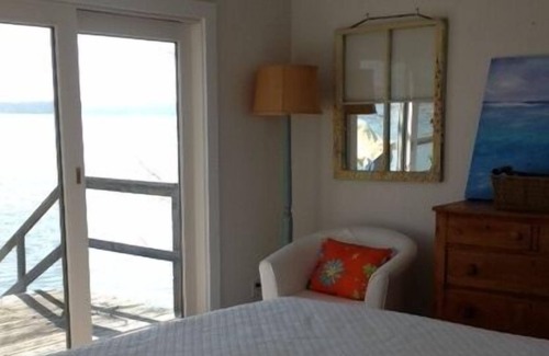 Lake Township Cottage | Sought-After West-End, Designer Cottage Right on Water
